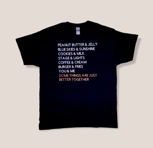 Black tshirt with white and red writing of items that make good pairs. Last line says some things are just better together